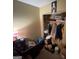 Bedroom with a packed closet, desk with scattered items, a lamp, and a picture hanging on the wall at 2009 Oak Park Ln, Decatur, GA 30032