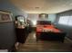 A cozy bedroom featuring hardwood floors, a dark wood bed frame, and natural light through the window at 2009 Oak Park Ln, Decatur, GA 30032