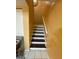 View of the stairs with tile flooring on the landing and wood stairs and risers at 2009 Oak Park Ln, Decatur, GA 30032