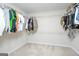 Walk-in closet with shelving and rods to maximize storage and light gray carpet at 232 Shelton Cir, Temple, GA 30179