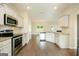 Modern kitchen with stainless steel appliances, granite countertops, and dark hardwood flooring at 232 Shelton Cir, Temple, GA 30179