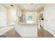 Open-concept kitchen with granite island, stainless steel appliances, and hardwood floors at 232 Shelton Cir, Temple, GA 30179