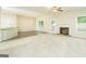 Open living room features a fireplace, carpet, and view to the kitchen at 232 Shelton Cir, Temple, GA 30179