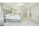 Large main bedroom with tray ceiling, light gray walls and carpet with ensuite bathroom at 232 Shelton Cir, Temple, GA 30179