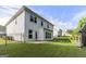 A fenced backyard with a freshly cut green lawn, patio, and a view of the home's white exterior at 129 Academy Ln, Canton, GA 30114