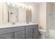 A bathroom featuring a tiled floor, double sink vanity with gray cabinets, and a separate shower and bathtub at 129 Academy Ln, Canton, GA 30114