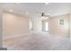 Spacious bonus room featuring neutral carpet and natural light from the window and door at 129 Academy Ln, Canton, GA 30114