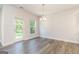 Bright dining area with access to the outdoor patio through a glass door and featuring a chandelier at 129 Academy Ln, Canton, GA 30114