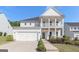 Charming two-story home featuring a welcoming double porch and attached two-car garage at 129 Academy Ln, Canton, GA 30114