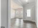 Bright foyer with wood-look floors leading into a dining space with a chandelier at 129 Academy Ln, Canton, GA 30114