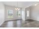 Bright and airy foyer with modern light fixture, with views to adjacent dining room at 129 Academy Ln, Canton, GA 30114