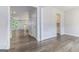 Hallway leading to open-concept living spaces, featuring modern flooring and neutral walls at 129 Academy Ln, Canton, GA 30114