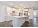 Modern kitchen with white cabinetry, stainless steel appliances, and a large center island at 129 Academy Ln, Canton, GA 30114