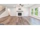 Bright living room with a fireplace, hardwood floors, and large windows providing natural light at 129 Academy Ln, Canton, GA 30114