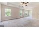Bright primary bedroom featuring neutral carpet, large windows, and an attached bonus room at 129 Academy Ln, Canton, GA 30114