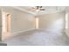 Serene primary bedroom features neutral carpet, tray ceiling, and an attached en-suite bathroom at 129 Academy Ln, Canton, GA 30114