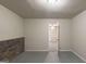 Basement featuring brick wall and neutral paint with an doorway to another finished room at 5341 Terrytown Ln, Lithonia, GA 30038