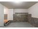Basement featuring a brick wall with a shelf on top and a door to a finished room at 5341 Terrytown Ln, Lithonia, GA 30038
