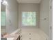 Bright bathroom featuring a large garden tub with granite countertop at 5341 Terrytown Ln, Lithonia, GA 30038