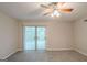 Bedroom showcasing new carpet, ceiling fan, and sliding doors to the backyard pool at 5341 Terrytown Ln, Lithonia, GA 30038