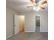 Bedroom with new carpet, ceiling fan and an open doorway to the fireplace room at 5341 Terrytown Ln, Lithonia, GA 30038