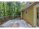 Outdoor deck features a wood railing and view of a mature trees at 5341 Terrytown Ln, Lithonia, GA 30038