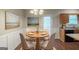 Cozy dining area adjacent to kitchen with a round table set for four and stylish wainscoting at 5341 Terrytown Ln, Lithonia, GA 30038