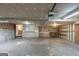 Unfinished garage with shelving, lighting, and a workbench providing ample storage space at 5341 Terrytown Ln, Lithonia, GA 30038