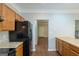 Bright kitchen featuring wood cabinets, granite countertops, and black appliances at 5341 Terrytown Ln, Lithonia, GA 30038
