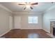 Inviting living room with stone fireplace and neutral walls, complete with ceiling fan, and wood-look floors at 5341 Terrytown Ln, Lithonia, GA 30038