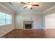 Bright living room featuring a stone fireplace, natural light, wood-look floors and a ceiling fan at 5341 Terrytown Ln, Lithonia, GA 30038