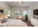 Serene bedroom featuring a comfortable bed, neutral decor, a ceiling fan and ample natural light at 5341 Terrytown Ln, Lithonia, GA 30038