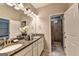 Bright bathroom features double sink vanity with granite countertop and tiled walk-in shower at 711 Topsail Ln, Alpharetta, GA 30005