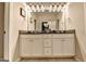 Bathroom with double sinks, white cabinets, and decorative lighting at 711 Topsail Ln, Alpharetta, GA 30005