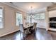 Light filled dining room featuring a wooden table, six chairs, and dark wood floors at 711 Topsail Ln, Alpharetta, GA 30005