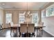 Dining room with a table and chairs. Windows and a chandelier provide ample lighting at 711 Topsail Ln, Alpharetta, GA 30005