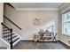 Entryway featuring dark wood floors, a staircase, and a decorative console table at 711 Topsail Ln, Alpharetta, GA 30005