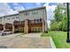 Back view of townhome with brick garages and upper-level decks, providing outdoor living spaces at 711 Topsail Ln, Alpharetta, GA 30005
