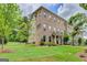 Brick townhouse exterior featuring well-maintained landscaping and inviting curb appeal at 711 Topsail Ln, Alpharetta, GA 30005