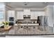 Close up shot of a granite countertop, a stainless steel sink, and stainless steel appliances at 711 Topsail Ln, Alpharetta, GA 30005