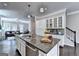 Kitchen island with granite countertops and stainless steel appliances, leading into living area at 711 Topsail Ln, Alpharetta, GA 30005