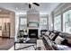 Comfortable living area featuring a fireplace and a glimpse into the kitchen at 711 Topsail Ln, Alpharetta, GA 30005