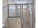 Stylish tiled shower with glass enclosure and a window for natural light at 711 Topsail Ln, Alpharetta, GA 30005