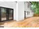 Backyard features a wooden deck, exterior doors, and a view of the white house at 2487 Highland Se Dr, Conyers, GA 30013