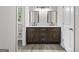 Bathroom with and sinks, framed mirrors, updated fixtures and vanity at 2487 Highland Se Dr, Conyers, GA 30013