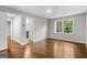 An empty bedroom with hardwood floors has a view of greenery outside the window at 2487 Highland Se Dr, Conyers, GA 30013