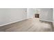 View of a bedroom that leads to a full bathroom and features new gray wood-look flooring at 2487 Highland Se Dr, Conyers, GA 30013