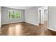 A vacant bedroom features hardwood floors and a window showing a green view at 2487 Highland Se Dr, Conyers, GA 30013