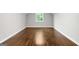 An empty bedroom has hardwood floors, white trim, and a window at 2487 Highland Se Dr, Conyers, GA 30013