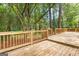 A large wooden deck, perfect for outdoor entertaining, in a backyard with mature trees at 2487 Highland Se Dr, Conyers, GA 30013